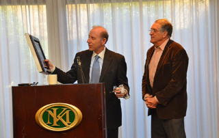 Jerry Blackman gives plaque and gavel to outgoing President Dan Kowler